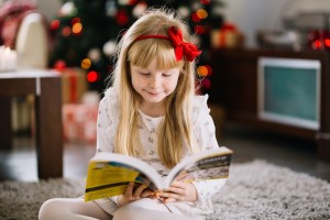 girl-reading-front-christmas-tree